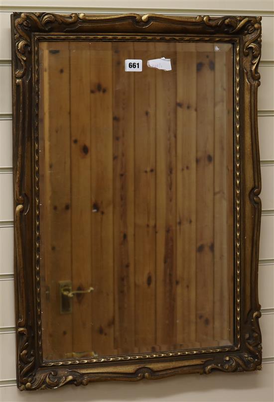 A bevelled wall mirror, H.70cm